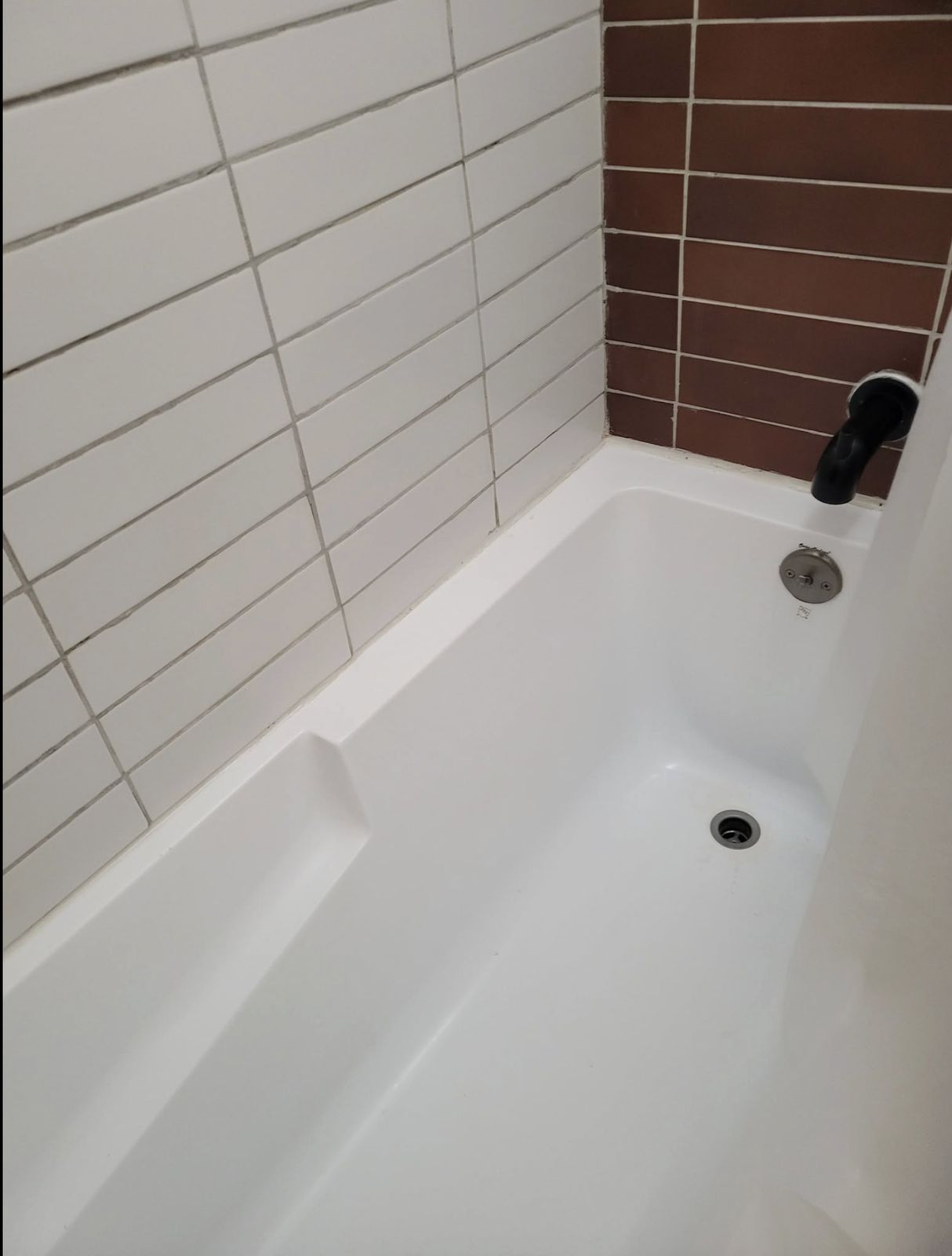 Spotless bathtub and tile after a turnover clean
