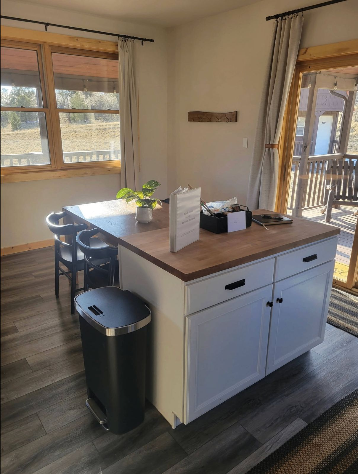 Kitchen island with welcome binder, guest guide, and mountain view beyond