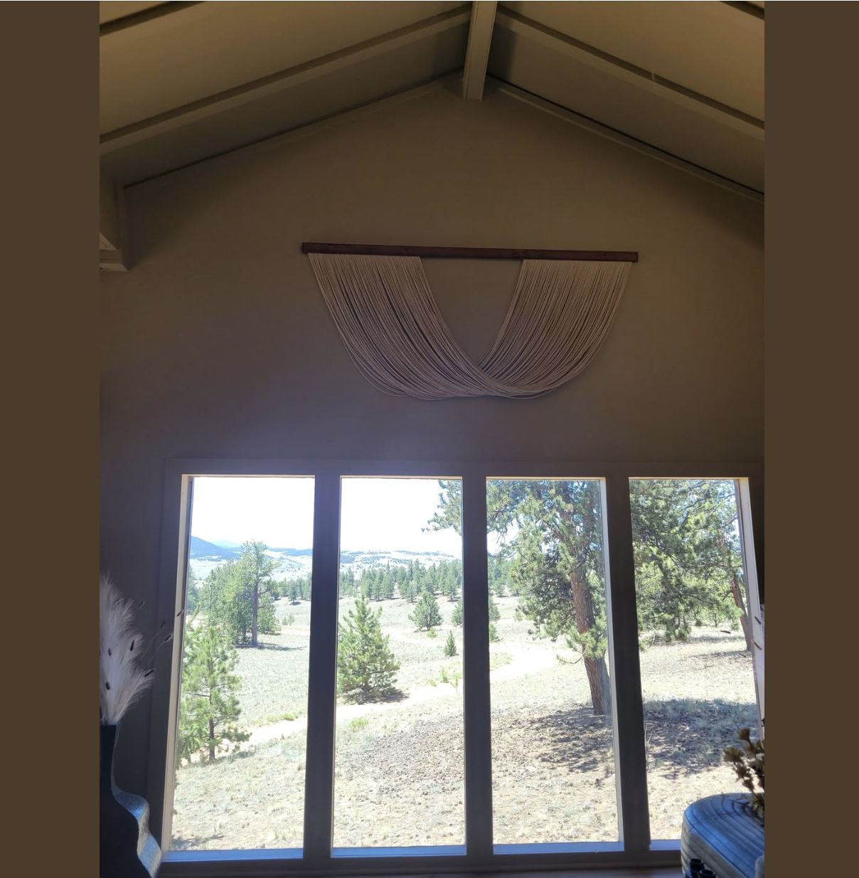 Vaulted great room with valley and pine forest views